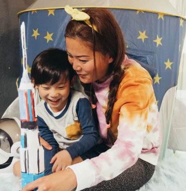 Asian single mother smiling with her son, representing the best home loan options for single parents.